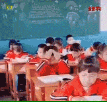 Boy scooping information from a book in a classroom on his head